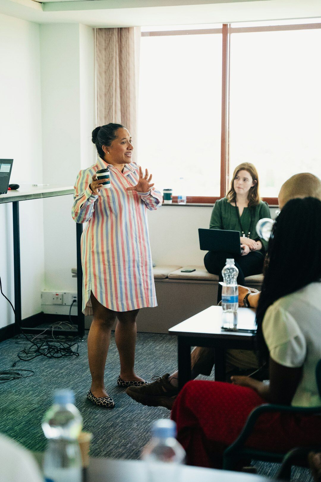 People practicing public speaking in a training room