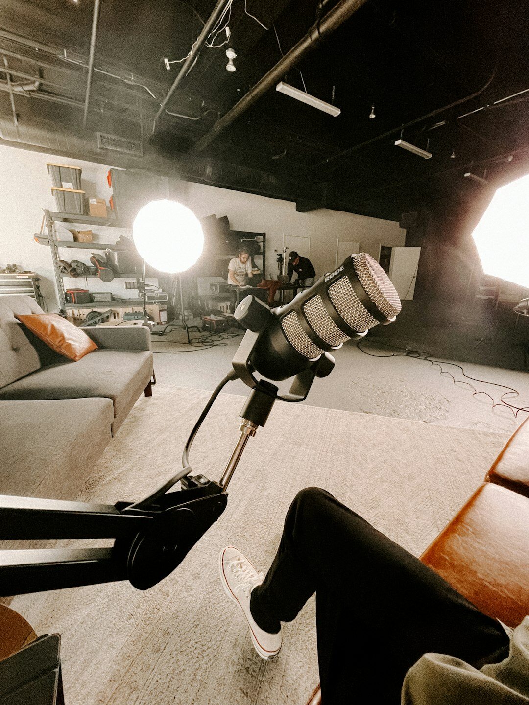 Presenter speaking into a microphone in a podcast studio