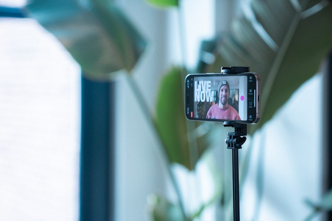 Person rehearsing a speech in front of a smartphone on a tripod